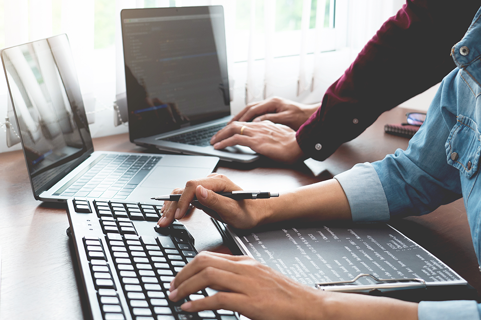 Team of Programmer working to find solution to problem and coding technologies in a software developing company office.