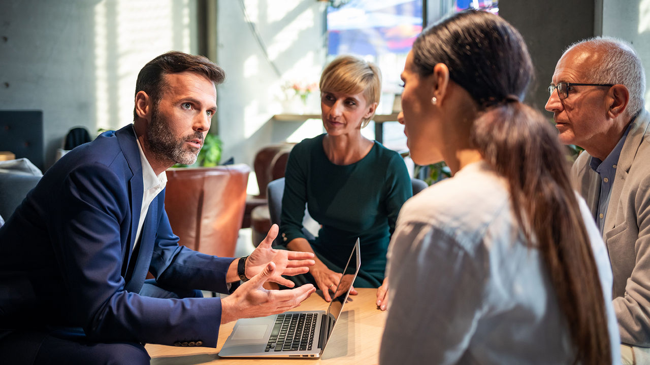 Business people talking about project in a cafe